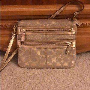 Gold coach crossbody with gold leather strap